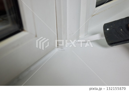 Sealing the corners of windows with caulk for achieving a perfectly neat and polished finish Sealing the corners of windows with caulk for achieving a perfectly neat and polished finish 132155870