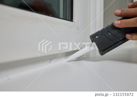 Sealing the corners of windows with caulk for achieving a perfectly neat and polished finish Sealing the corners of windows with caulk for achieving a perfectly neat and polished finish 132155872
