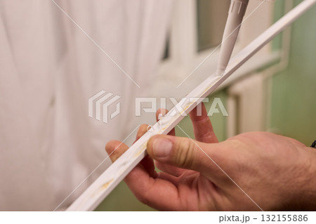Hand Applying Adhesive with a Caulking Gun for Various Home Interior and Exterior Projects Hand Applying Adhesive with a Caulking Gun for Various Home Interior and Exterior Projects 132155886