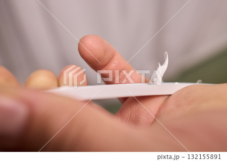 Hand Applying Adhesive with a Caulking Gun for Various Home Interior and Exterior Projects 132155891