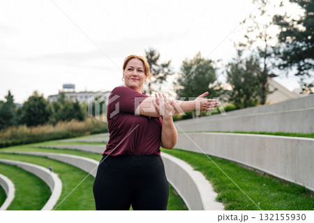 Body positive woman warming up before training. Body positive woman warming up before training. 132155930
