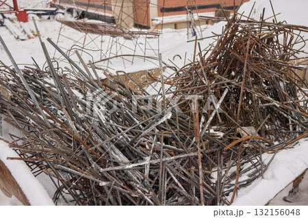 A construction site with piles of organized reinforced steel bars being prepared for use A construction site with piles of organized reinforced steel bars being prepared for use 132156048