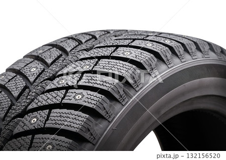 Close-up view of winter studded tire showcasing tread pattern and seasonal design on a white background for effective sales presentation Close-up view of winter studded tire showcasing tread pattern and seasonal design on a white background for effective sales presentation 132156520