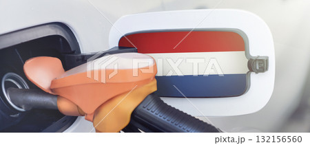 Flag of the Netherlands on the lid of the gas tank of a car at a gas station in close-up. High or low gasoline prices at Dutch gas stations. Gasoline prices are rising due to a shortage of diesel fuel 132156560