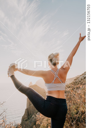 Yoga, Outdoors, Woman - Woman performs yoga pose outdoors with a scenic view. 132156703