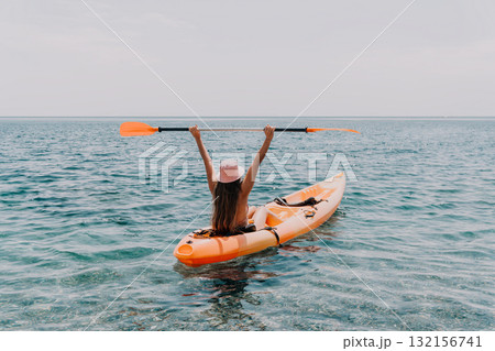 Kayaking Woman Sea Happy Woman in Kayak Raises Arms in Triumph on Ocean Kayaking Woman Sea Happy Woman in Kayak Raises Arms in Triumph on Ocean 132156741
