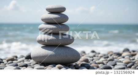 Zen Stone Balance Minimalism Perfectly stacked beach pebbles creating abstract vertical sculpture against unfocused ocean background in monochromatic palette without 132156924
