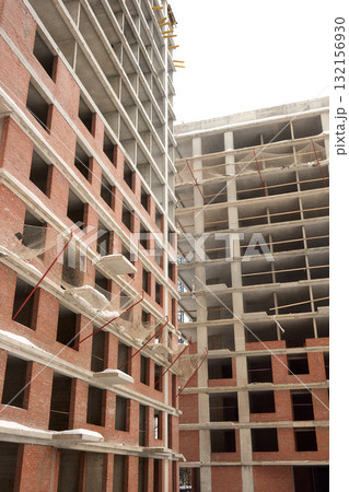 A bustling Construction Site showcasing Cranes, Building Framework, and full activity all around A bustling Construction Site showcasing Cranes, Building Framework, and full activity all around 132156930