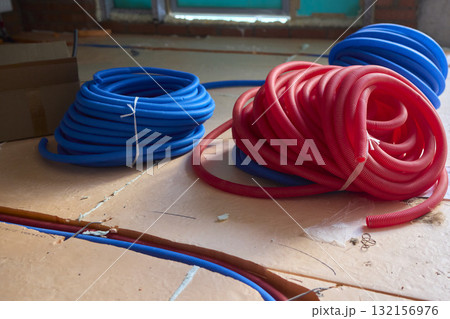 Vibrantly Colored Coiled Hoses Ideal for Plumbing Needs or Electrical Applications 132156976