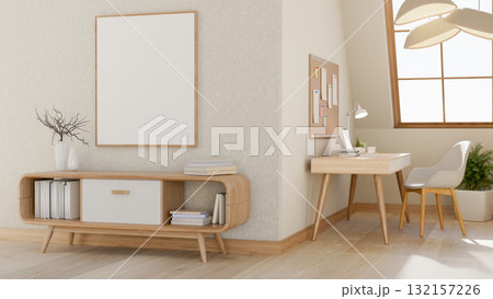 A blank frame hanging above wooden table near a room corner with desk and armchair under roof window 132157226