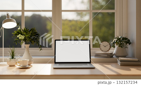 White screen laptop with coffee and clock over book on wooden table with potted plants under window White screen laptop with coffee and clock over book on wooden table with potted plants under window 132157234