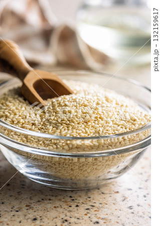 Roasted sesame seeds in bowl on kitchen table. 132159617