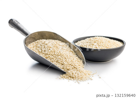 Roasted sesame seeds on scoop isolated on white background. 132159640