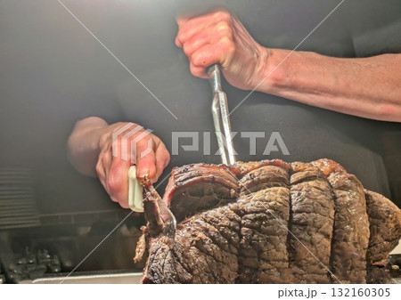 Hands carving roast beef 132160305