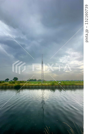 Stunning Tranquil Landscape Featuring Tower Beautifully Reflected in Serene Water Body Stunning Tranquil Landscape Featuring Tower Beautifully Reflected in Serene Water Body 132160739