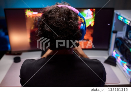 Enjoying an exciting gaming session with a controller and large screen for immersive gameplay 132161316