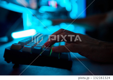 A Close Up View of Hands Actively Typing on a Vibrant and Colorful Mechanical Keyboard 132161324