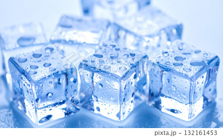 A high-resolution macro image of melting ice cubes with water droplets on a cool blue background. 132161453