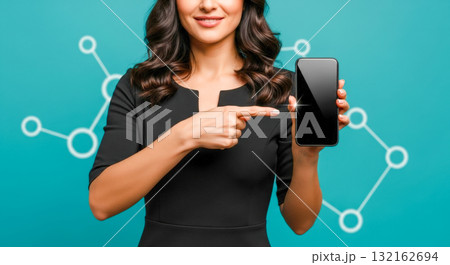 Smiling business woman pointing finger at smartphone with blank black screen, showing mobile app or website, isolated on turquoise background with network icons 132162694