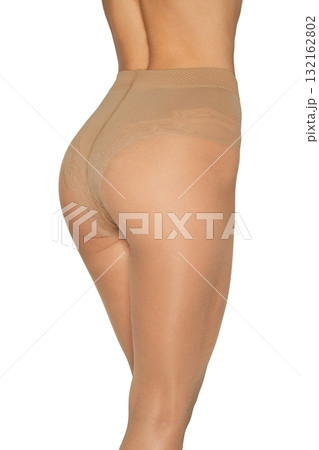 Rear view of fit female legs in beige tights on white background Rear view of fit female legs in beige tights on white background 132162802