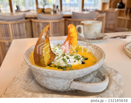 Pumpkin soup with pumpkin seeds, cream and baked pumpkin in the restaurant Pumpkin soup with pumpkin seeds, cream and baked pumpkin in the restaurant 132165638