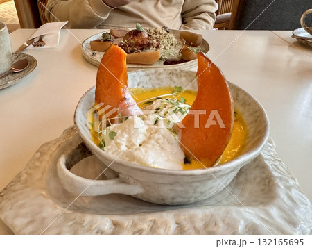 Pumpkin soup with pumpkin seeds, cream and baked pumpkin in the restaurant 132165695
