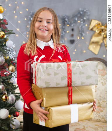 Happy girl with a box of gifts on the background of the Christmas tree on holiday of Christmas Happy girl with a box of gifts on the background of the Christmas tree on holiday of Christmas 132166667