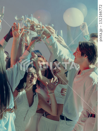 Smiling friends raising glasses at elegant Valentine day celebration Smiling friends raising glasses at elegant Valentine day celebration 132166772