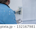 Worker applying plaster to a wall during renovation 132167981