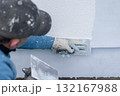 Worker applying stucco plaster on building wall exterior 132167988
