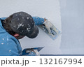 Worker plastering stucco on building exterior wall 132167994