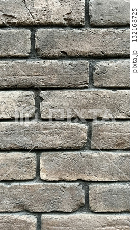 Textured close-up of a rustic brick wall showcasing earthy tones and sturdy construction methods Textured close-up of a rustic brick wall showcasing earthy tones and sturdy construction methods 132168725