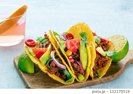 Ground beef tacos and a Paloma cocktail, Mexican food and drink, a close-up 132170519