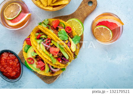 Tacos and Paloma cocktails, Mexican food and drink, overhead flat lay shot Tacos and Paloma cocktails, Mexican food and drink, overhead flat lay shot 132170521