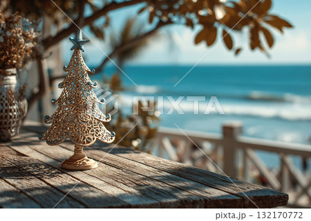 Wooden Christmas tree decorated with shells on the beach. Wooden Christmas tree decorated with shells on the beach. 132170772