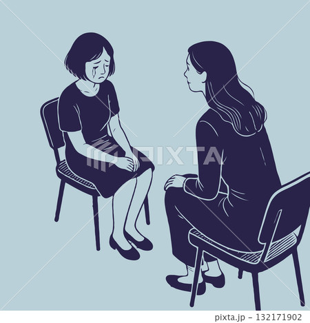 Woman comforting a crying girl during emotional conversation on chairs indoors. Concept of mental health support 132171902