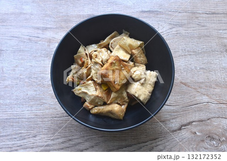 fried slice yellow tofu and gypsum with celery in soy sauce vegetarian food on bowl fried slice yellow tofu and gypsum with celery in soy sauce vegetarian food on bowl 132172352