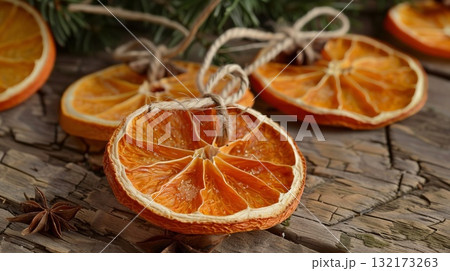 Dried orange slices with twine for decoration, set on a soft background. Christmas decor and craftwork, eco friendly, sustainable, zero waste concept. Dried orange slices with twine for decoration, set on a soft background. Christmas decor and craftwork, eco friendly, sustainable, zero waste concept. 132173263