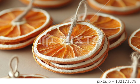 Dried orange slices arranged in a decorative manner. Christmas decor and craftwork, eco friendly, sustainable, zero waste concept. Dried orange slices arranged in a decorative manner. Christmas decor and craftwork, eco friendly, sustainable, zero waste concept. 132173379