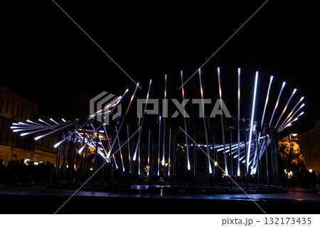 The fascinating night scene captures a modern light installation that dominates the space with a futuristic aesthetic and consists The fascinating night scene captures a modern light installation that dominates the space with a futuristic aesthetic and consists 132173435