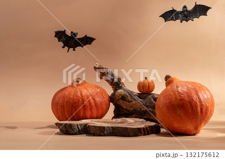 Empty wooden log on table with pumpkin and bats. Halloween or Thanksgiving mock up for products. 132175612