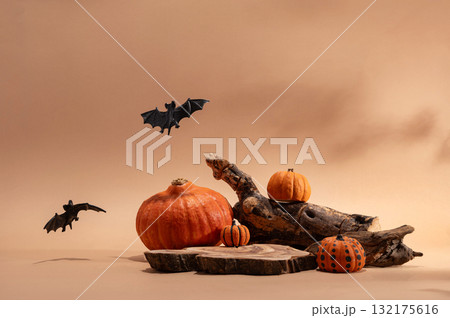 Empty wooden log on table with pumpkin and bats. Halloween or Thanksgiving mock up for products. 132175616