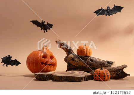 Empty wooden log on table with pumpkin and bats. Halloween or Thanksgiving mock up for products. Empty wooden log on table with pumpkin and bats. Halloween or Thanksgiving mock up for products. 132175653