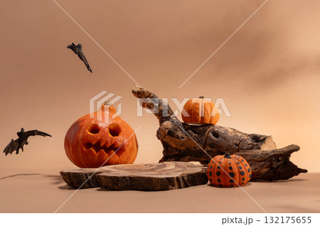 Empty wooden log on table with pumpkin and bats. Halloween or Thanksgiving mock up for products. Empty wooden log on table with pumpkin and bats. Halloween or Thanksgiving mock up for products. 132175655