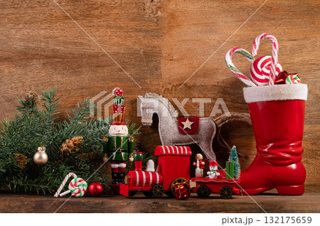 Saint Nicholas Day or Nikolaus, german holiday, December 6. Children toys and shoes with traditional sweets. Saint Nicholas Day or Nikolaus, german holiday, December 6. Children toys and shoes with traditional sweets. 132175659