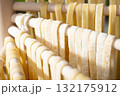 Homemade noodles hanging on wooden dryer rack closeup low angle view 132175912