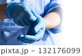 Healthcare Professional Donning Blue Medical Gloves 132176099