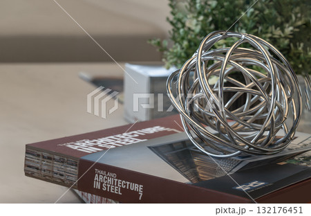 The decorative abstract sphere sculpture is known as the Liang & Eimil Twig Orb, also referred to as a wire ball or hollow ball. The decorative abstract sphere sculpture is known as the Liang & Eimil Twig Orb, also referred to as a wire ball or hollow ball. 132176451