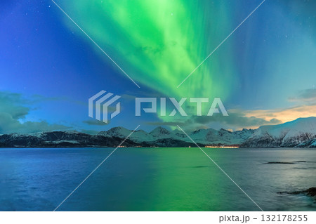 Tromso Norway, aurora borealis northern lights winter landscape at Rorvikneset Sommaroy 132178255