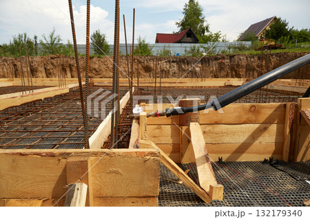 The construction of a concrete foundation using reinforcing steel prepared at the construction site. 132179340